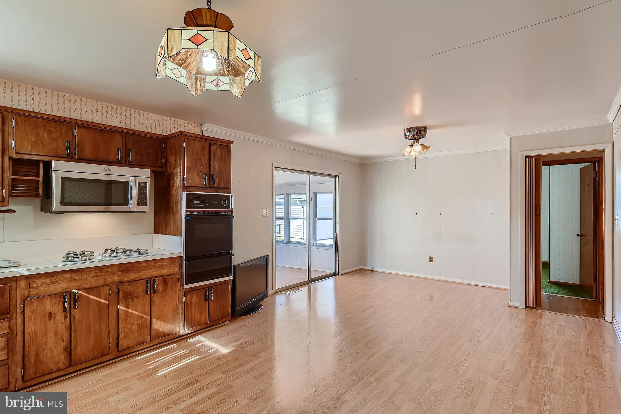 8918 Parlo Road Baltimore, MD 21236 - Photo 6 of 28 a view of a kitchen with wooden floor and electronic appliances