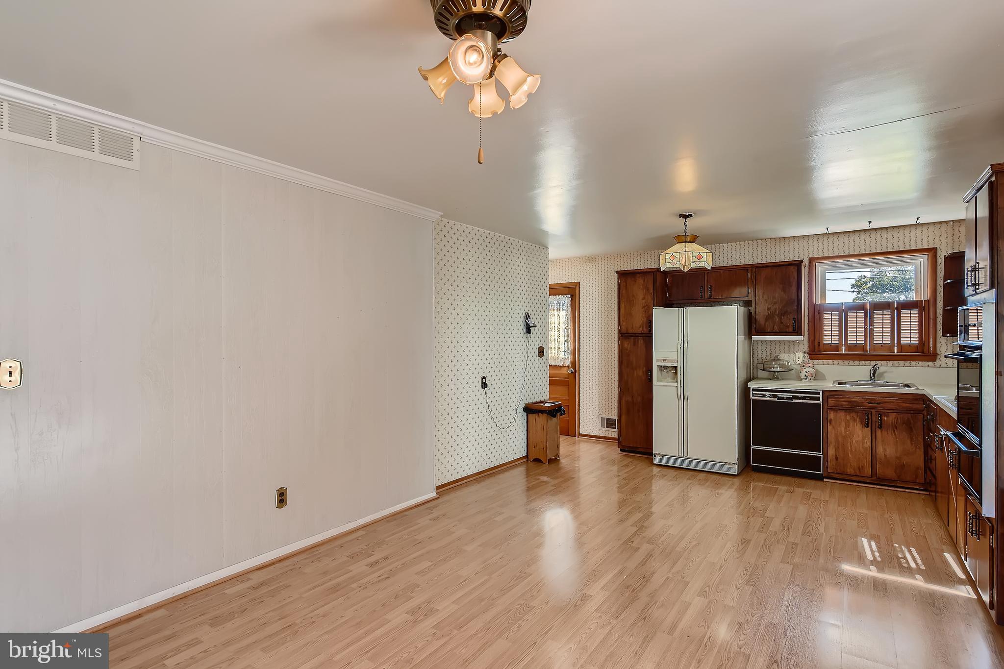 8918 Parlo Road Baltimore, MD 21236 - Photo 7 of 28 a view of a kitchen with refrigerator and wooden floor