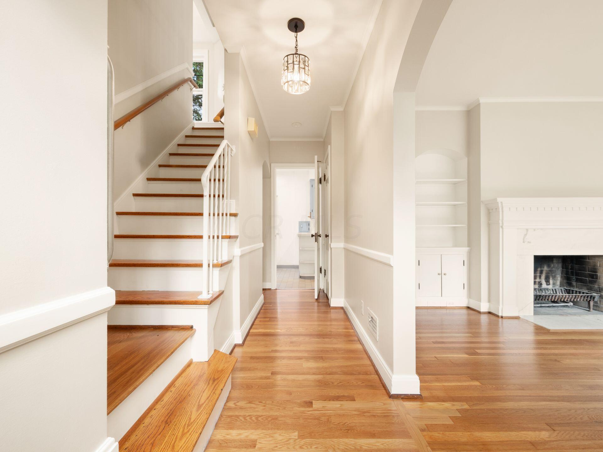 Enter into the hallway with living room to right