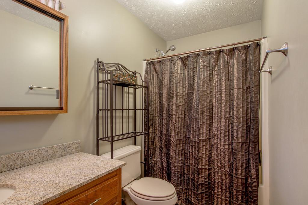 4002 Harding Place Springfield, TN 37172 - Photo 11 of 17 a bathroom with a granite countertop sink toilet and shower