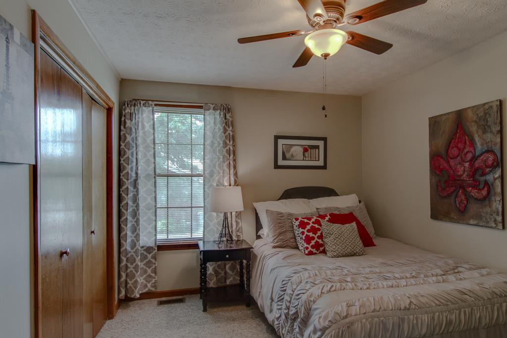 4002 Harding Place Springfield, TN 37172 - Photo 12 of 17 a bedroom with a bed and a chandelier