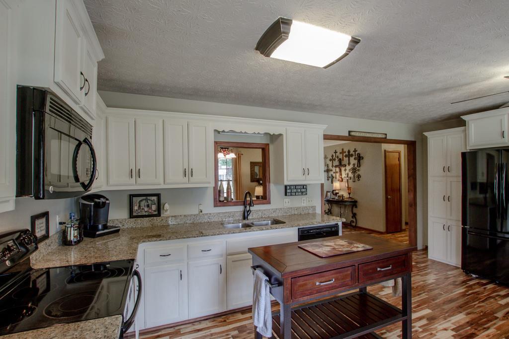 4002 Harding Place Springfield, TN 37172 - Photo 5 of 17 a kitchen with stainless steel appliances granite countertop a sink stove and refrigerator