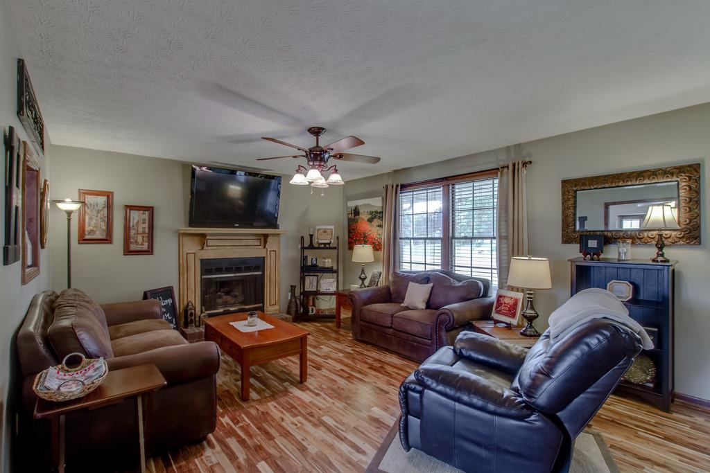 4002 Harding Place Springfield, TN 37172 - Photo 7 of 17 a living room with furniture a fireplace and a flat screen tv