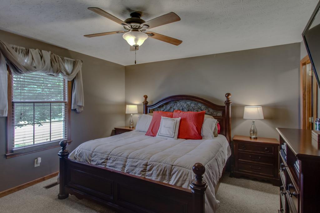 4002 Harding Place Springfield, TN 37172 - Photo 10 of 17 a bedroom with a bed and a chandelier