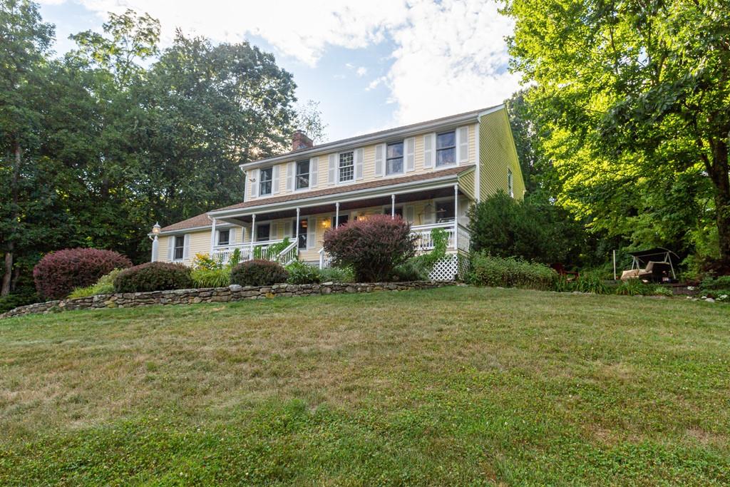 26 Bond Hollow Road Sutton, MA 01590 - Photo 3 of 38 a front view of a house with a garden