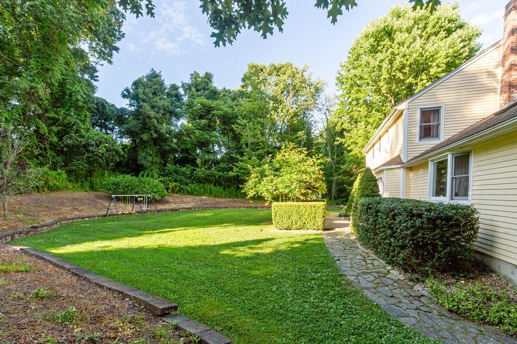 26 Bond Hollow Road Sutton, MA 01590 - Photo 8 of 38 a view of a white house with a big yard plants and large trees