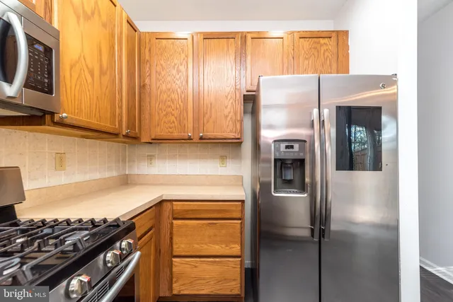 a kitchen with a refrigerator and a stove