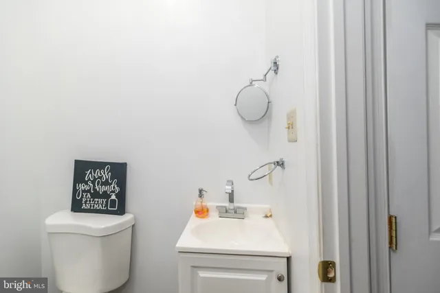 a bathroom with a sink a toilet and shower curtain