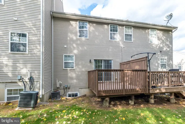 a view of a house with a yard and deck