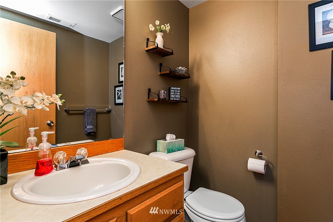 19602 9th Drive Southeast Bothell, WA 98012 - Photo 11 of 20 a bathroom with a sink and a mirror with toilet