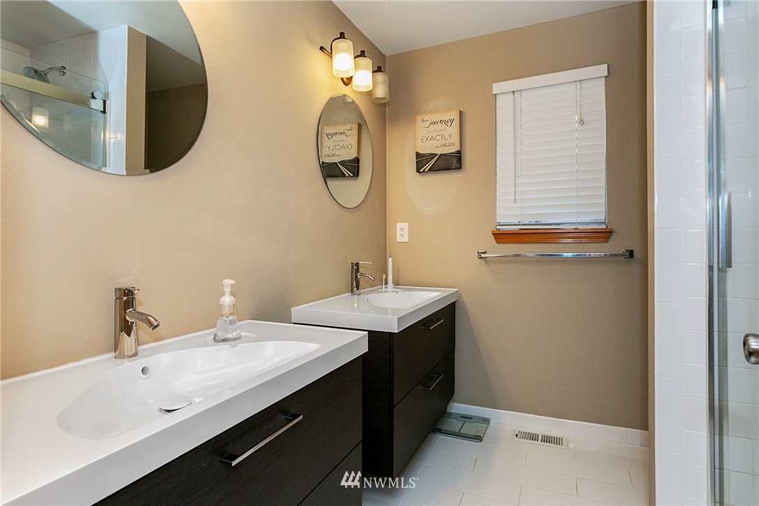 19602 9th Drive Southeast Bothell, WA 98012 - Photo 13 of 20 a bathroom with a double vanity sink mirror and toilet