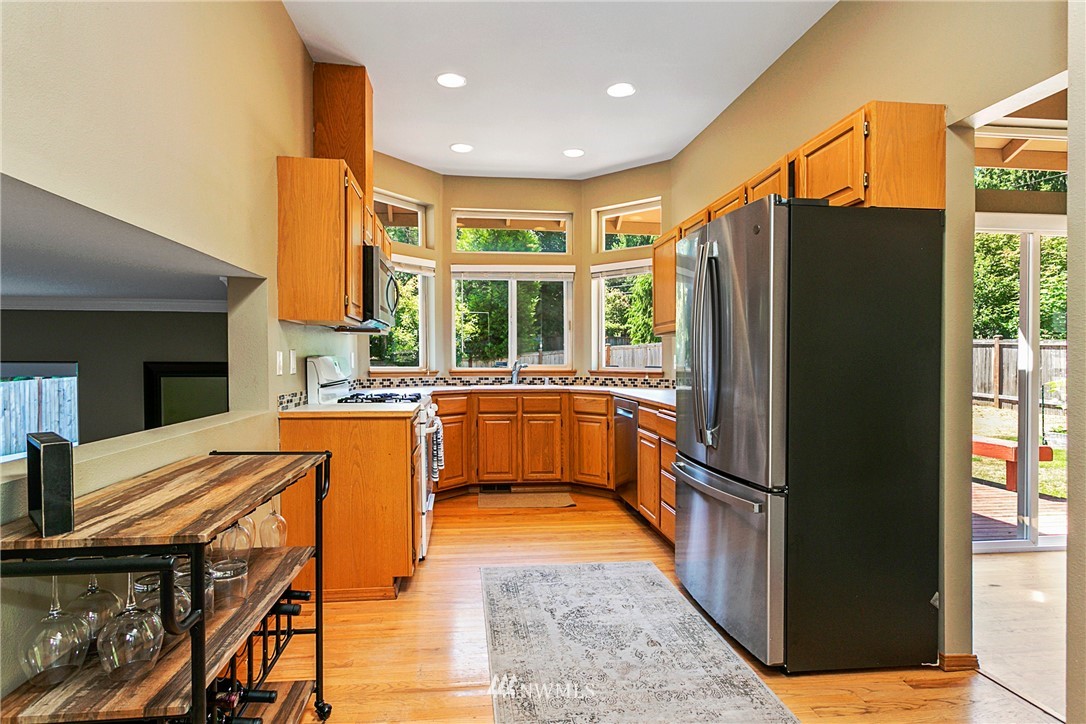 19602 9th Drive Southeast Bothell, WA 98012 - Photo 3 of 20 a kitchen with stainless steel appliances granite countertop a refrigerator a sink and a stove