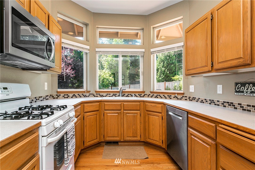 19602 9th Drive Southeast Bothell, WA 98012 - Photo 4 of 20 a kitchen with a sink stove and cabinets