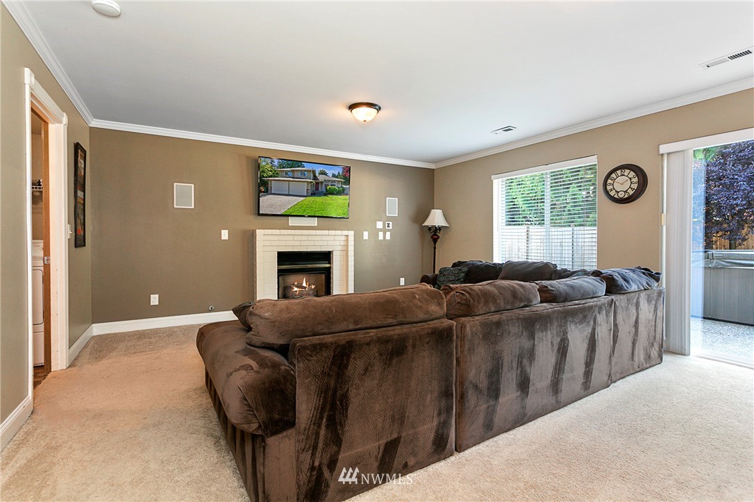 19602 9th Drive Southeast Bothell, WA 98012 - Photo 9 of 20 a living room with furniture a window and a fireplace