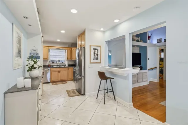 a kitchen with stainless steel appliances a refrigerator sink and microwave