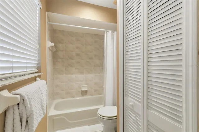 a bathroom with a sink a toilet a shower and a mirror