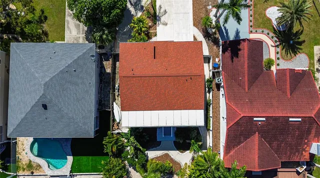 an aerial view of house with yard and swimming pool