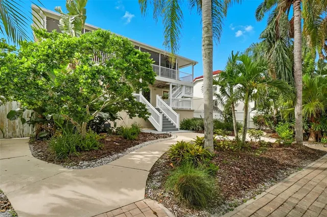 a view of a patio with chairs next to a yard