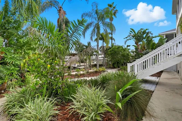 a view of a balcony with chairs and wooden floor