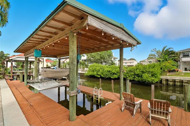 a view of a lake with boats and palm trees