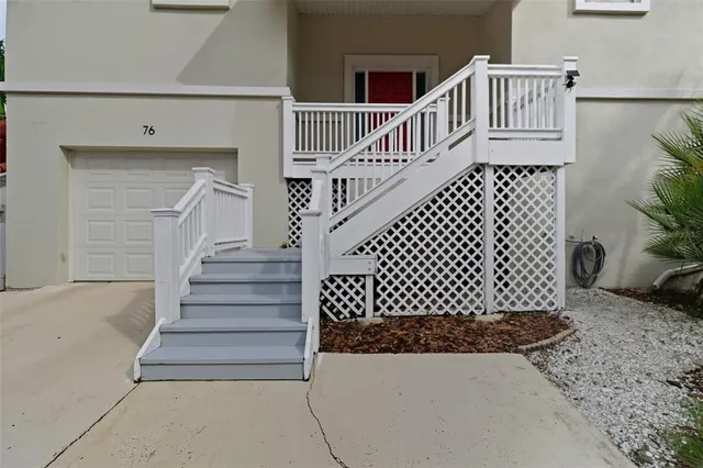 a view of staircase with wooden floor and white walls