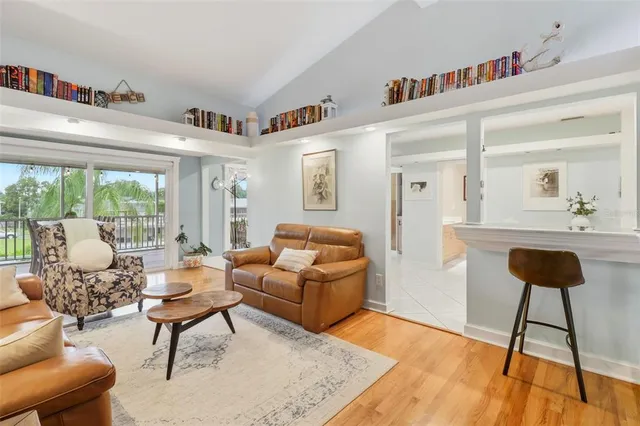 a living room with furniture a bookshelf and a large window