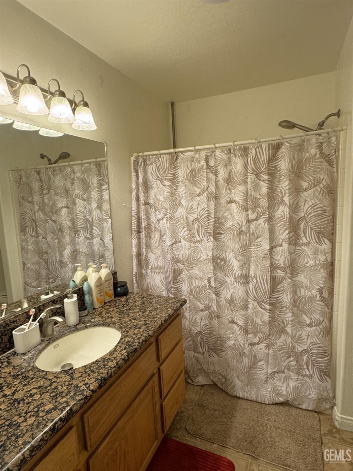 Undisclosed Address Tehachapi, CA 93561 - Photo 9 of 16 a bathroom with a granite countertop sink and a mirror