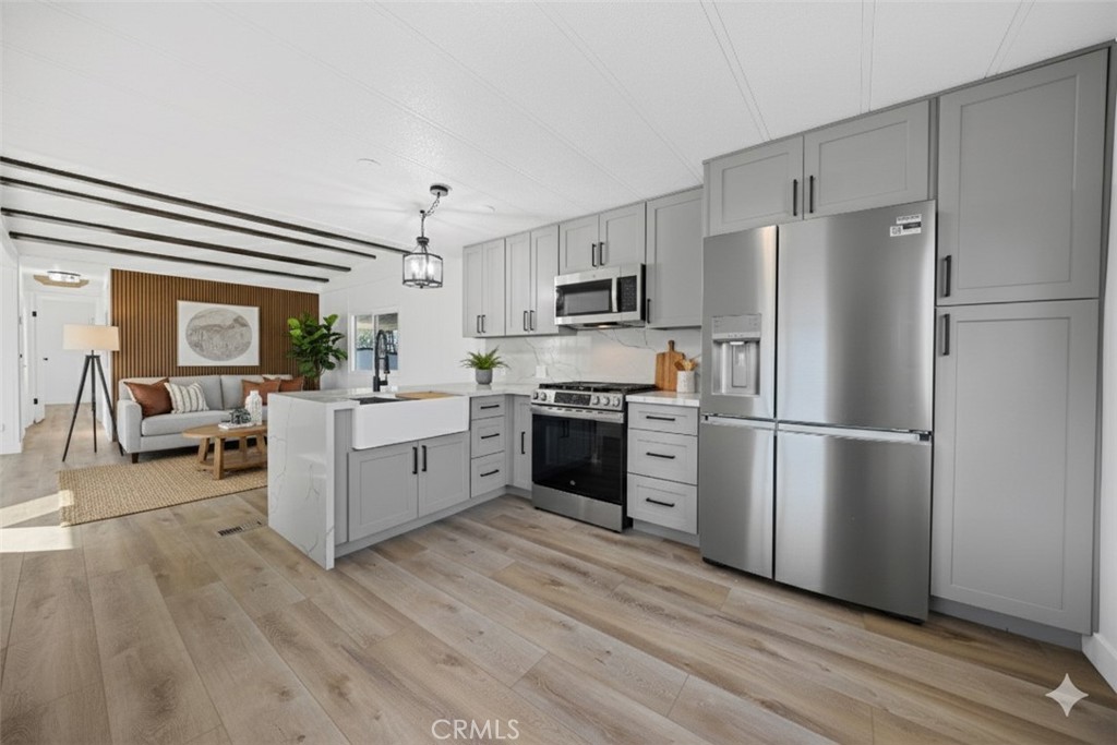 1255 Amethyst Street, Unit 51 Mentone, CA 92359 - Photo 1 of 60 a kitchen with stainless steel appliances a refrigerator sink and cabinets