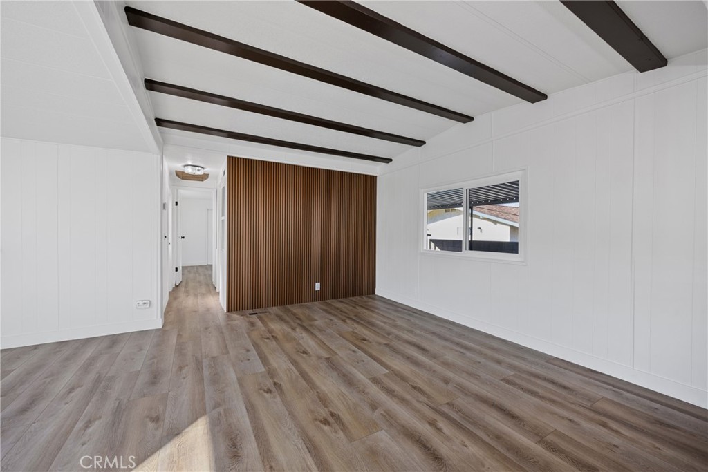 1255 Amethyst Street, Unit 51 Mentone, CA 92359 - Photo 13 of 60 a view of an empty room with wooden floor and a window