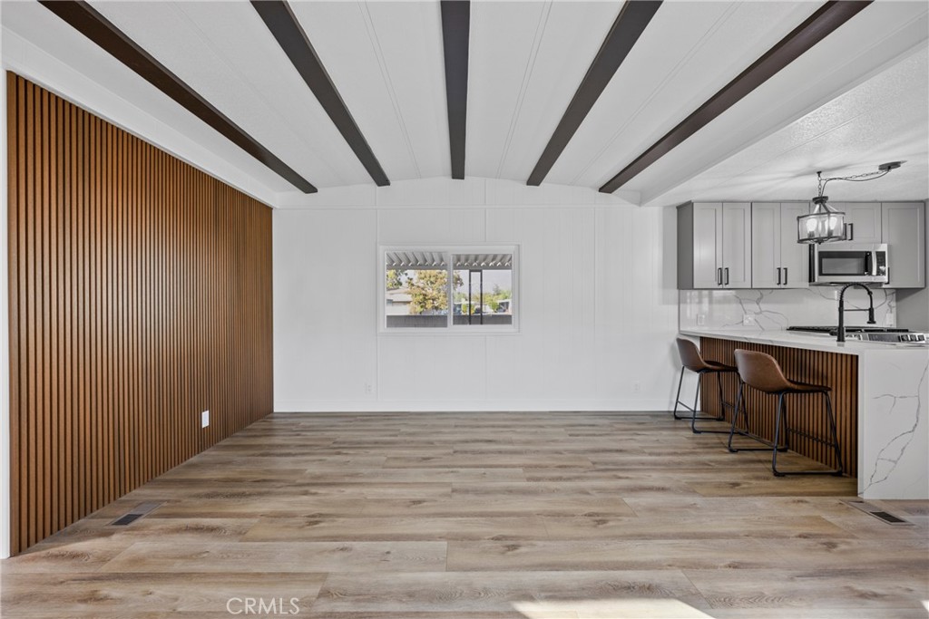 1255 Amethyst Street, Unit 51 Mentone, CA 92359 - Photo 18 of 60 a view of kitchen and dining room with wooden floor
