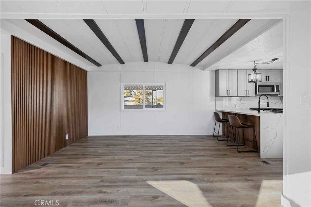 1255 Amethyst Street, Unit 51 Mentone, CA 92359 - Photo 19 of 60 a view of kitchen and dining room with wooden floor