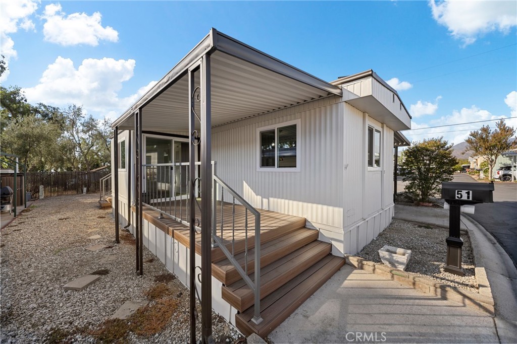 1255 Amethyst Street, Unit 51 Mentone, CA 92359 - Photo 32 of 60 a view of house with backyard and trees
