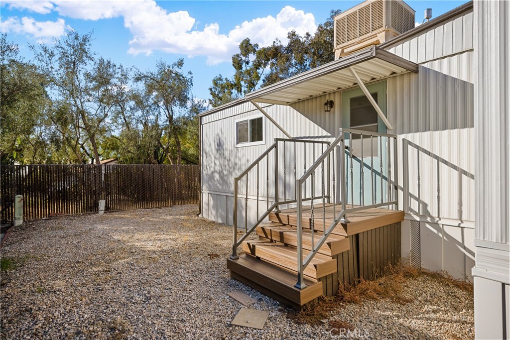 1255 Amethyst Street, Unit 51 Mentone, CA 92359 - Photo 33 of 60 a view of a house with a small yard and wooden fence
