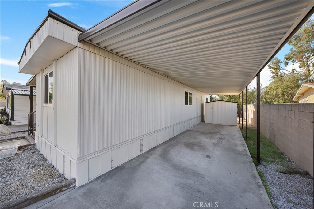 1255 Amethyst Street, Unit 51 Mentone, CA 92359 - Photo 38 of 60 a view of a white house with a small yard and wooden fence