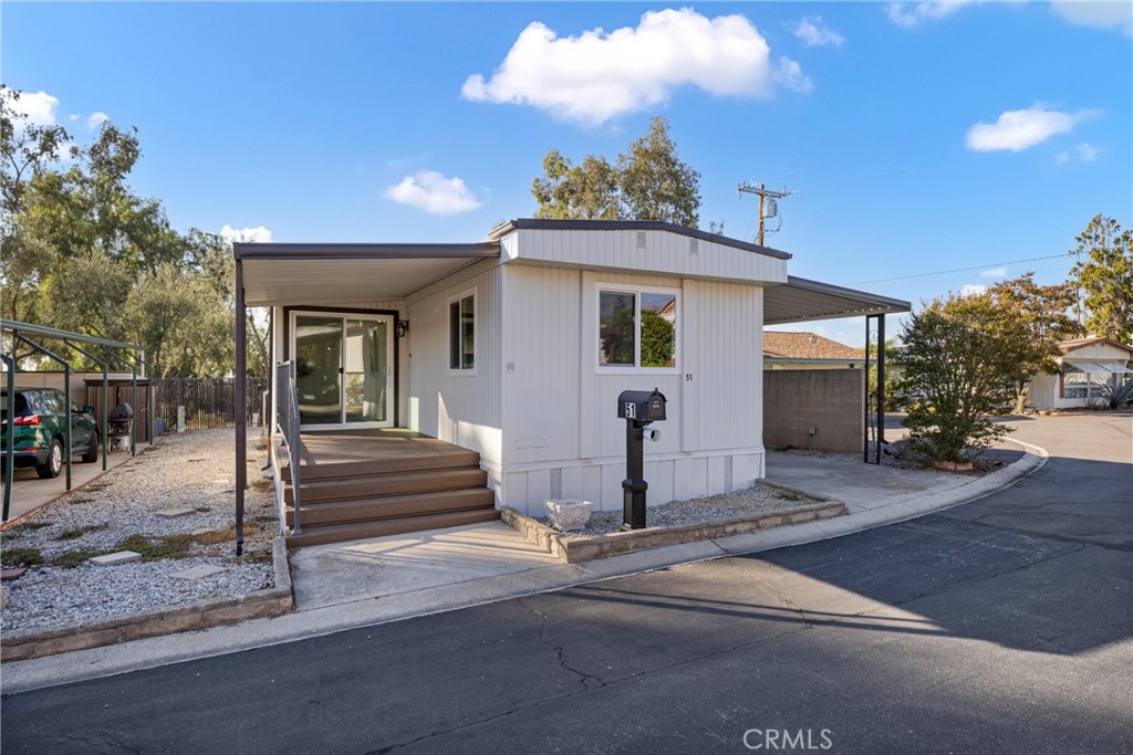 1255 Amethyst Street, Unit 51 Mentone, CA 92359 - Photo 43 of 60 a front view of a house with a tree