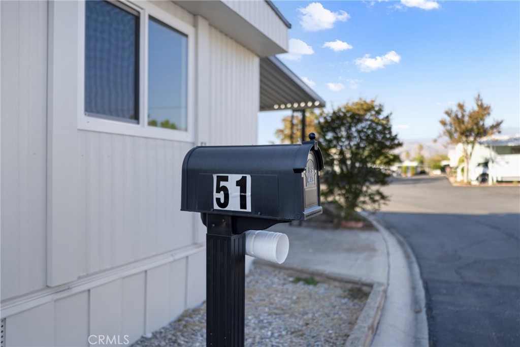 1255 Amethyst Street, Unit 51 Mentone, CA 92359 - Photo 53 of 60 a front view of a house with trees