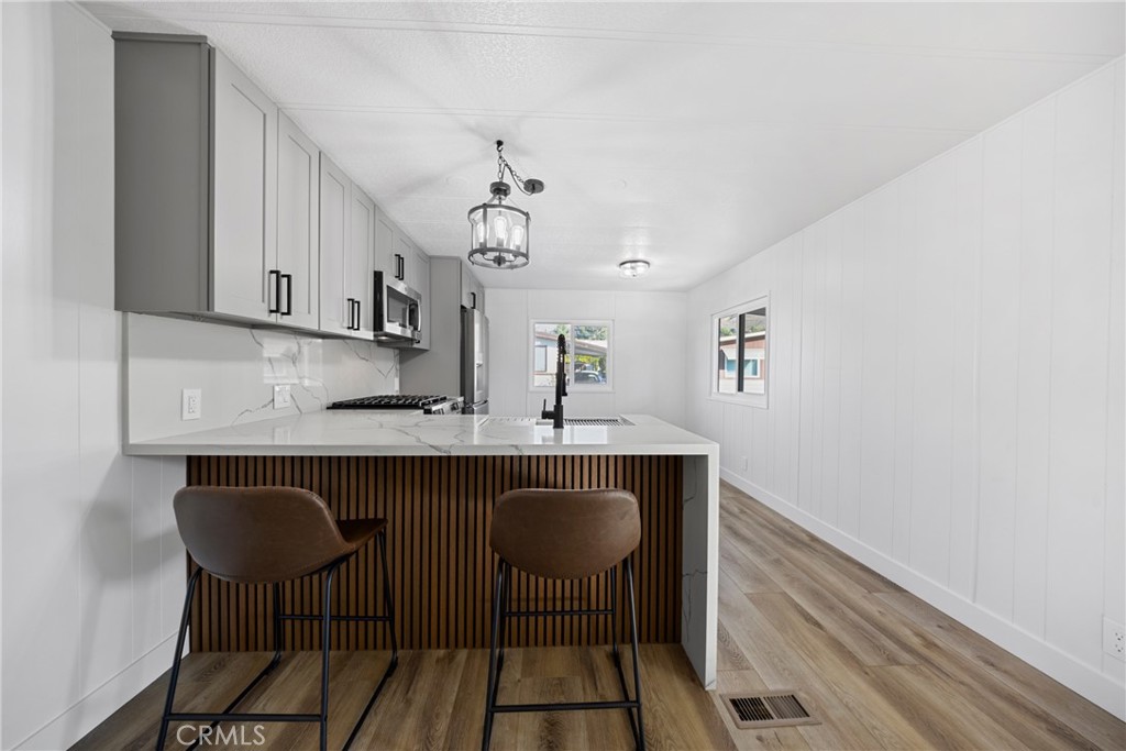 1255 Amethyst Street, Unit 51 Mentone, CA 92359 - Photo 8 of 60 a kitchen with stainless steel appliances a sink and cabinets