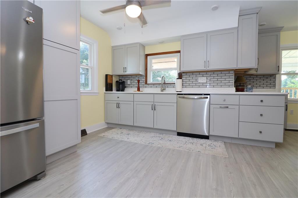 418 Pine Hill Road Kittanning, PA 16201 - Photo 6 of 20 a kitchen with white cabinets and white appliances