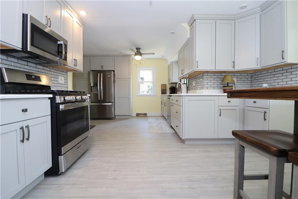 418 Pine Hill Road Kittanning, PA 16201 - Photo 8 of 20 a kitchen with a stove top oven and refrigerator
