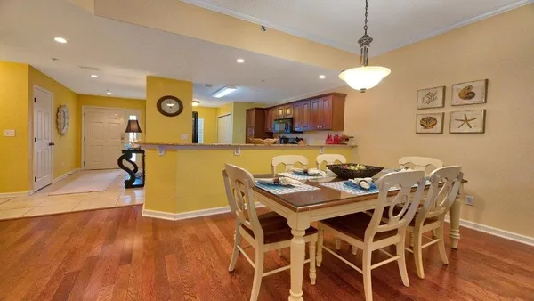a view of a dining room with furniture and wooden floor