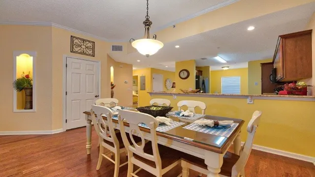a view of a a dining room with furniture window and wooden floor