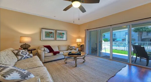 a living room with furniture and a wooden floor