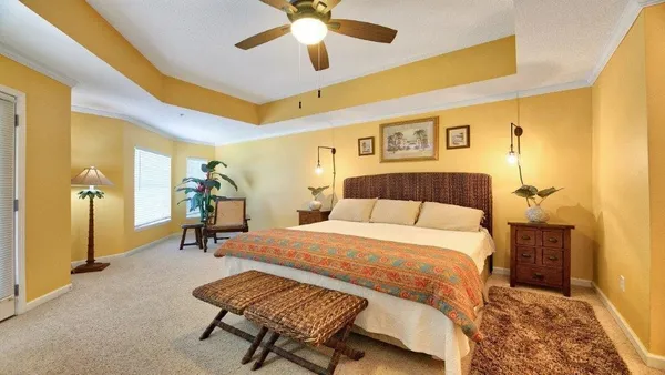 a bedroom with a bed and a chandelier