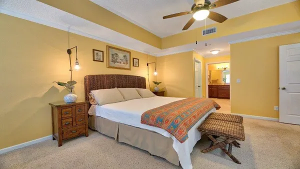 a bedroom with a bed and a chandelier