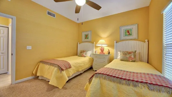 a bedroom with two beds and painted walls