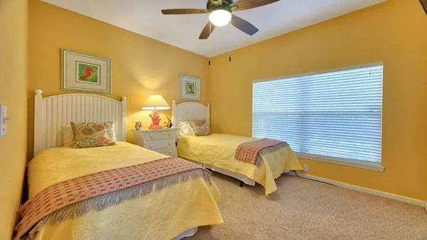 a bedroom with bed and a chandelier
