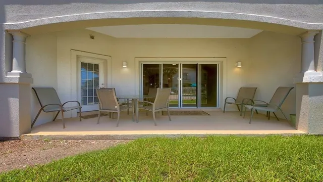 a view of a house with backyard porch and sitting area