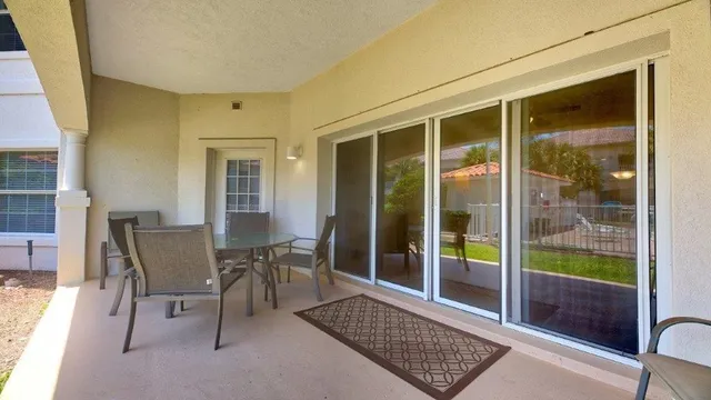 a view of a dining room with a table and chairs
