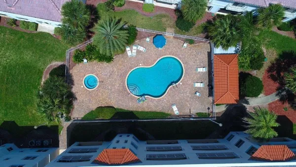 an aerial view of a house with yard swimming pool and outdoor seating