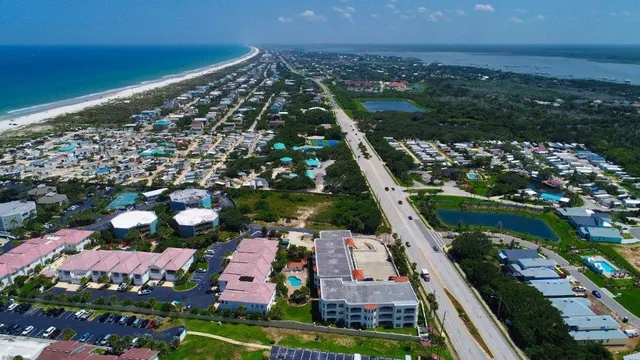 an aerial view of residential houses with outdoor space